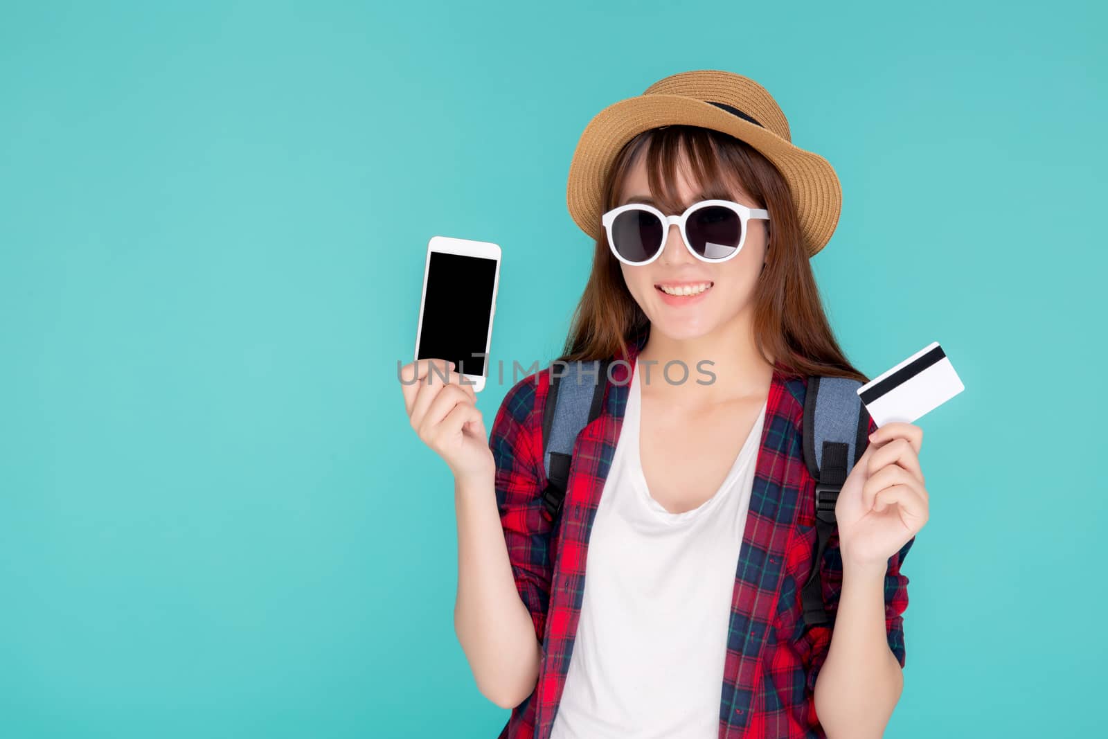 Beautiful portrait young asian woman wear travel summer fashion holding credit card and smart mobile phone in summer, asia girl payment for booking internet online with app in vacation.