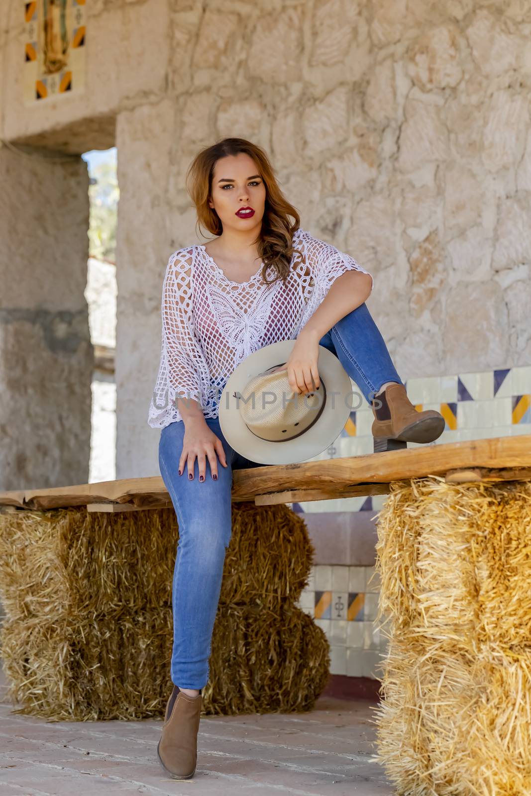 A gorgeous Hispanic Brunette model poses outdoors at a Mexican hacienda