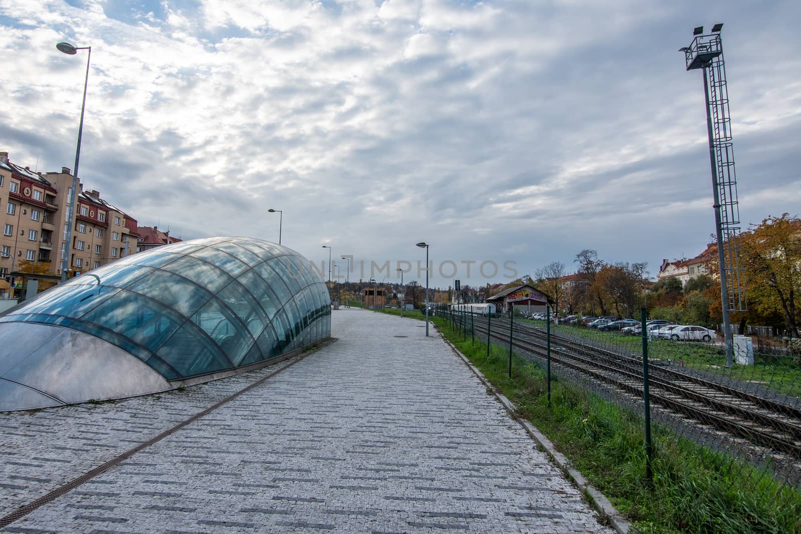Open view of a city in a grey strong autumn day with a tunnel to access the underground