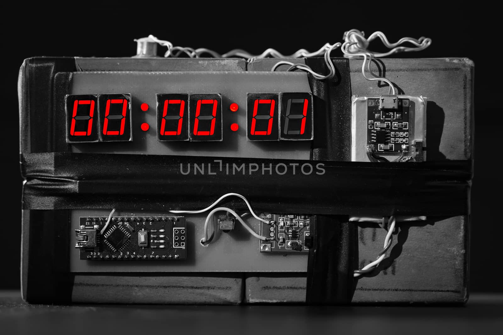 bw. Bomb with a Red Timer on Black Background. Dynamite is Going to Explode or Detonate per 1 Second. Time Bomb with Clockwork. Terrorist Threat. Explosives with Detonator. Improvised Explosive Device