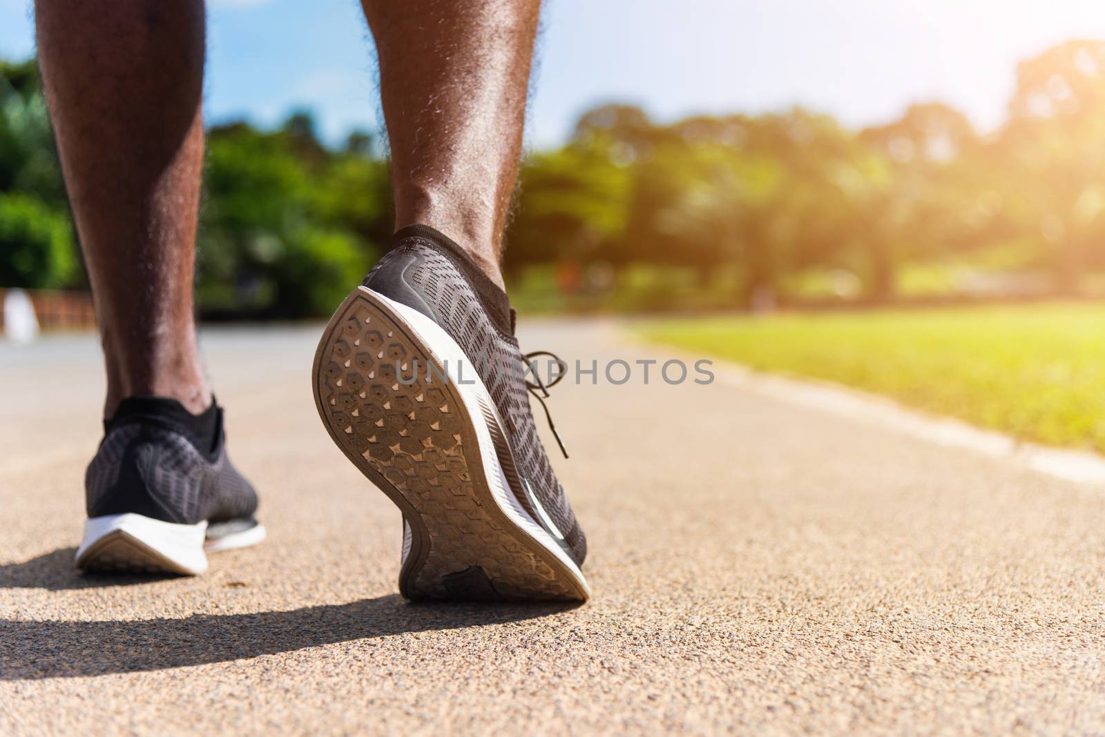 Asian young athlete sport runner black man wear feet active ready to running training at the outdoor on the treadmill line road for a step forward, healthy exercise workout, closeup back shoe