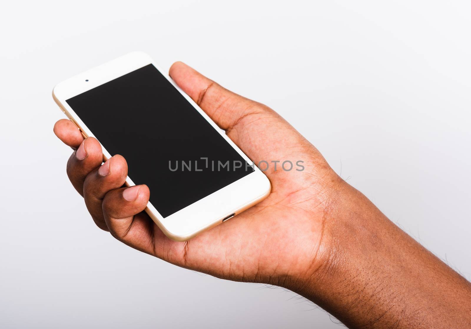 Closeup hand black man holding mockup white modern digital mobile smart phone blank screen on hand, studio shot isolated on white background