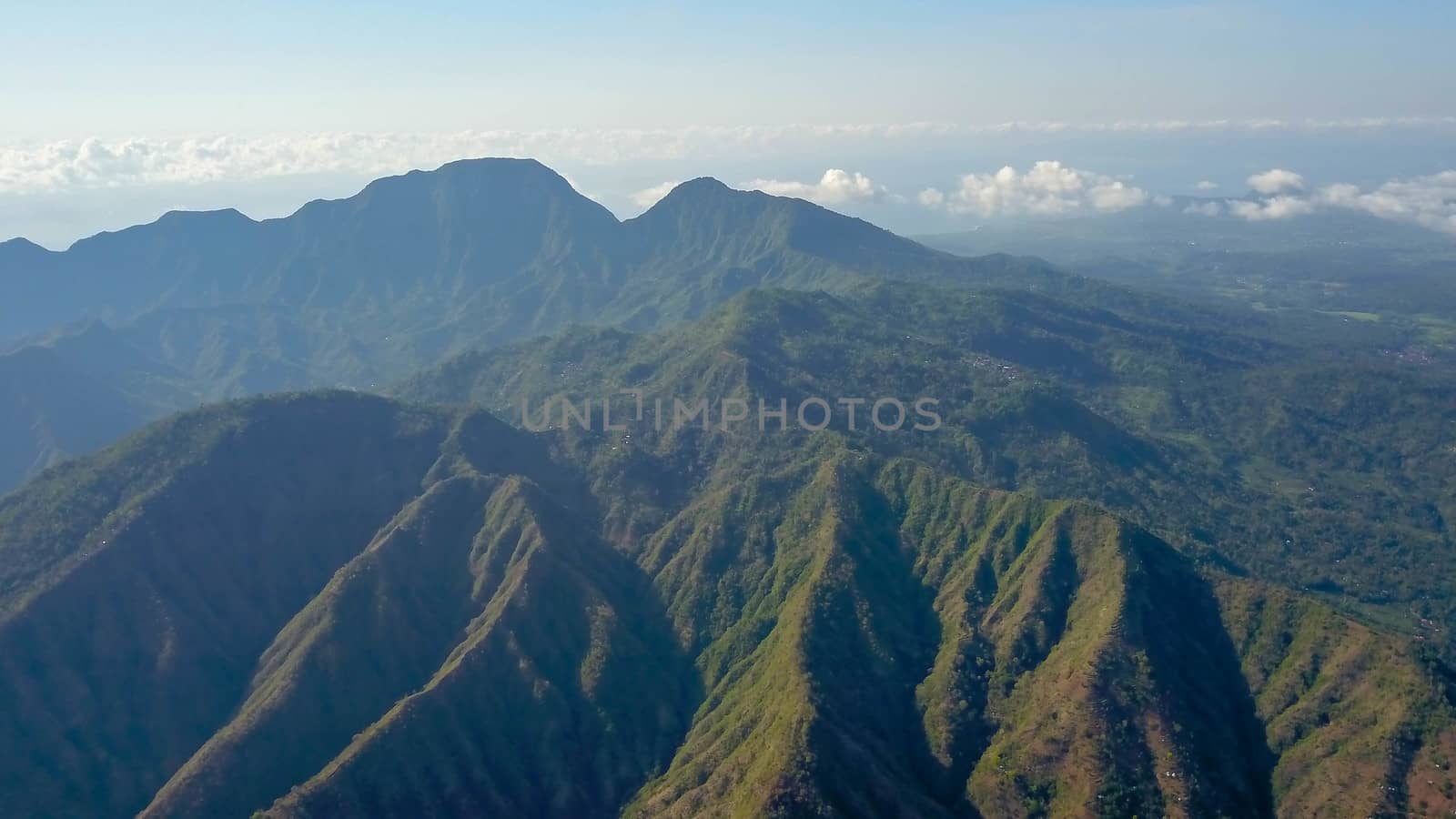 Mountainous landscape of Amed village. Aerial view of the mountains above the village, Bali, Indonesia. Lempuyang and Seraya mountains. Breathtaking panoramic view of the mountains in the tropics.