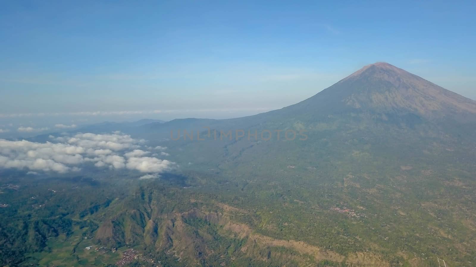 The volcano Gunung Agung dominating the horizon taken from Amed against a clear blue sky, a little fishing village located on the east coast of Bali, Indonesia.