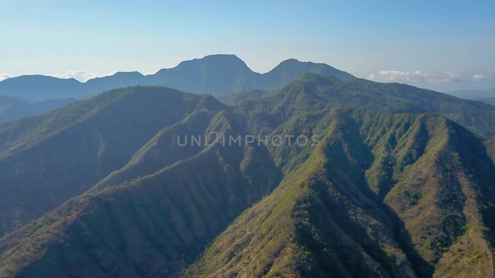 Mountainous landscape of Amed village. Aerial view of the mountains above the village, Bali, Indonesia. Lempuyang and Seraya mountains. Breathtaking panoramic view of the mountains in the tropics by Sanatana2008