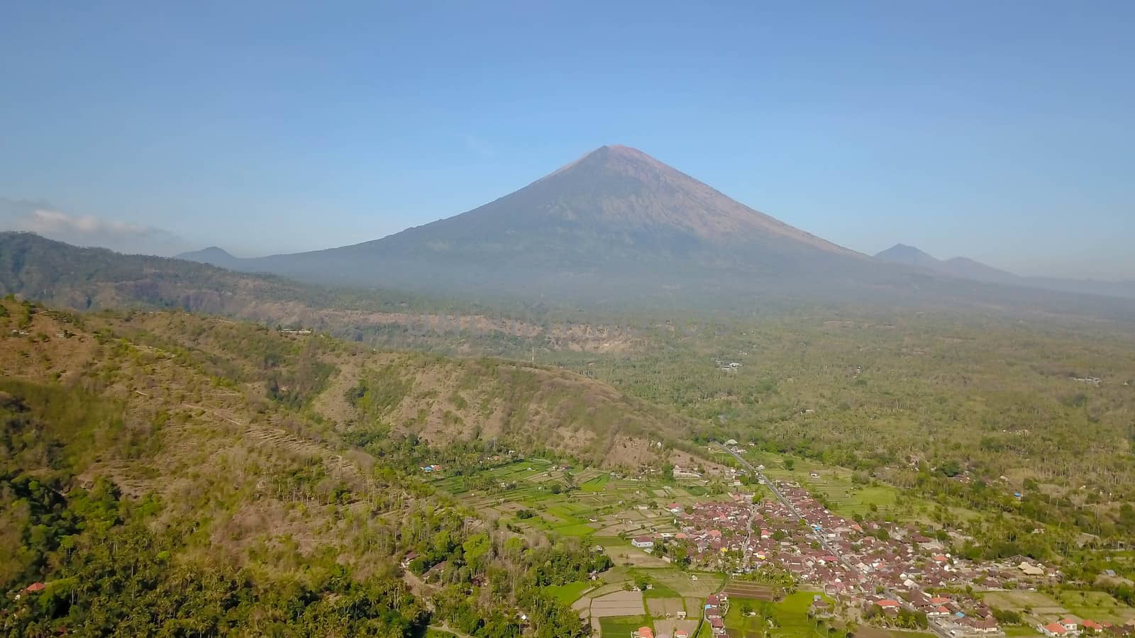 The volcano Gunung Agung dominating the horizon taken from Amed against a clear blue sky, a little fishing village located on the east coast of Bali, Indonesia.