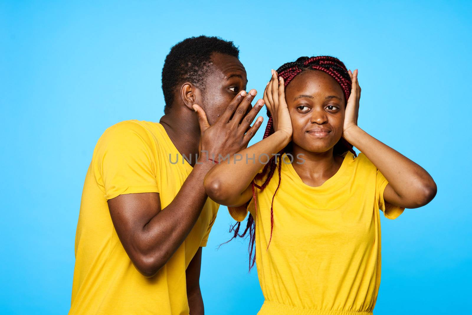 Man and woman in yellow T-shirts African appearance communication dating blue background