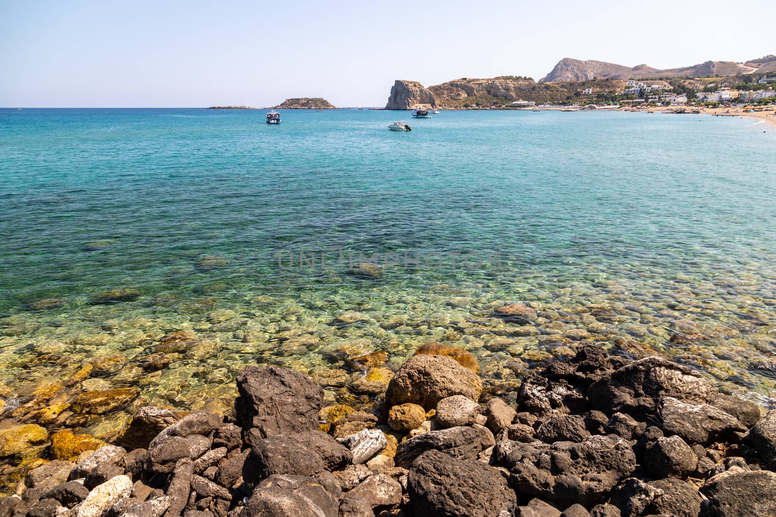 Stegna beach on Greek island Rhodes with rocky coastline and clear turquoise water on a sunny  day in spring