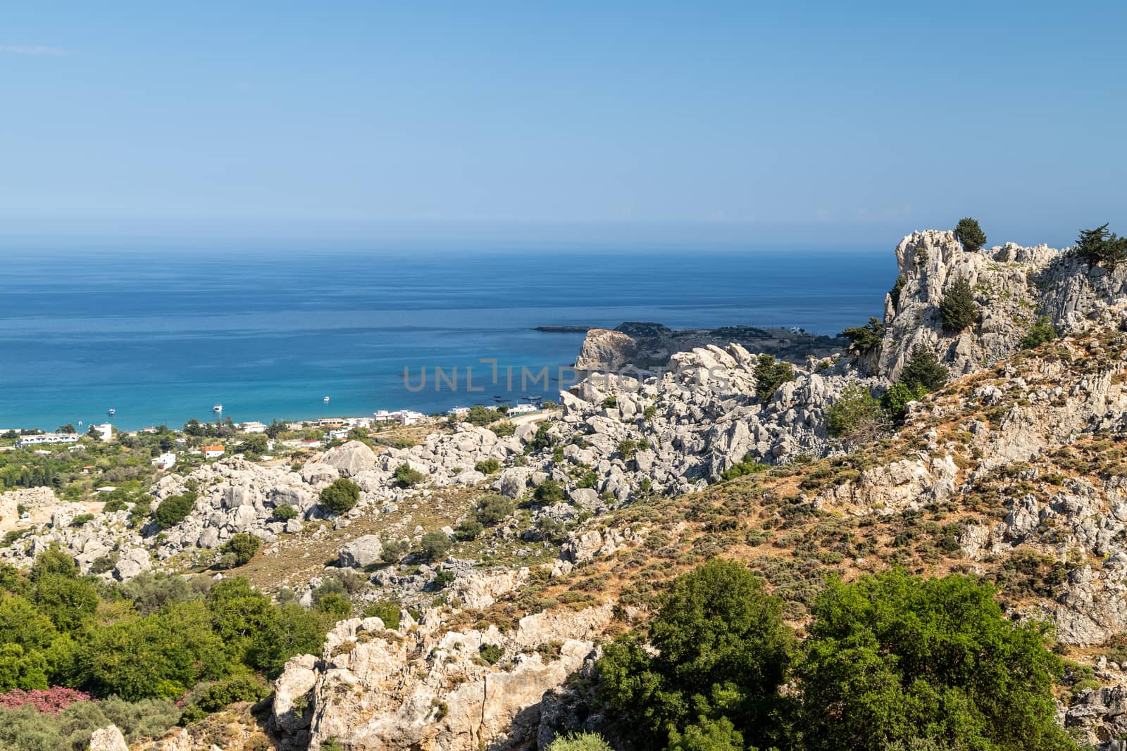 Scenic view at Stegna beach on Geek island Rhodes with rocks in the foreground and the mediterranean sea in the background on a sunny day in spring