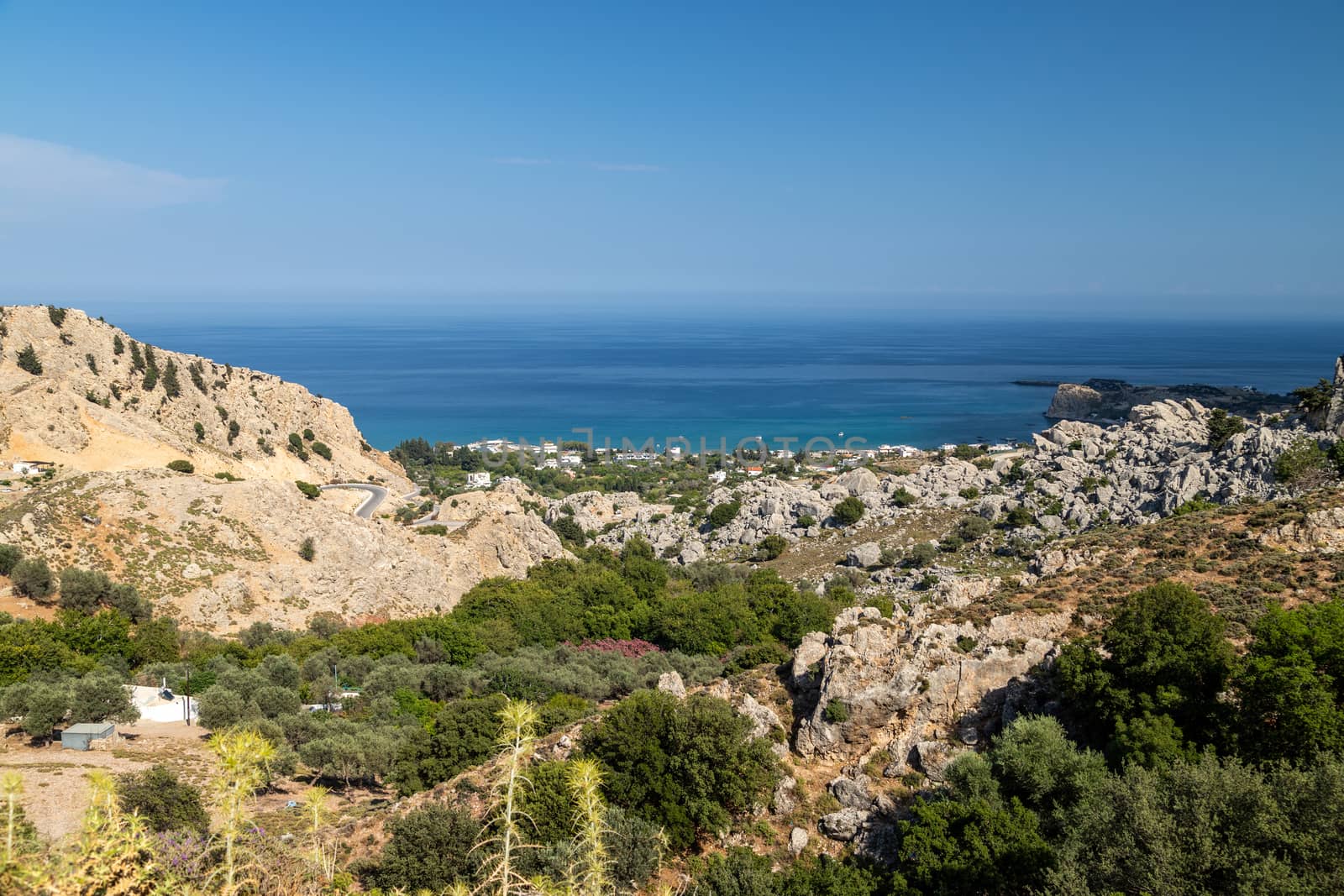 Scenic view at Stegna beach on Geek island Rhodes with rocks in the foreground and the mediterranean sea in the background on a sunny day in spring