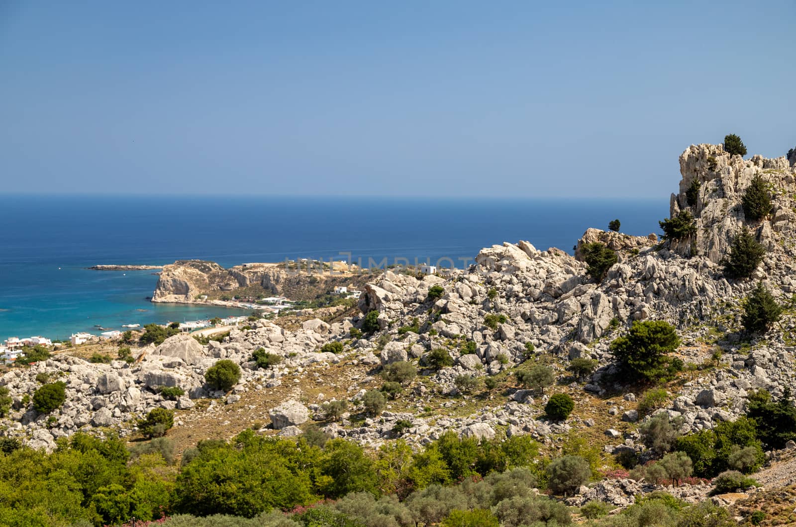 Scenic view at Stegna beach on Geek island Rhodes with rocks in the foreground and the mediterranean sea in the background on a sunny day in spring