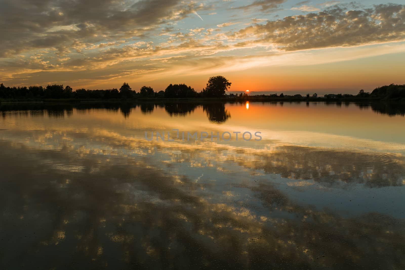 Reflection of clouds in a calm lake, view during sunset, Stankow, Poland