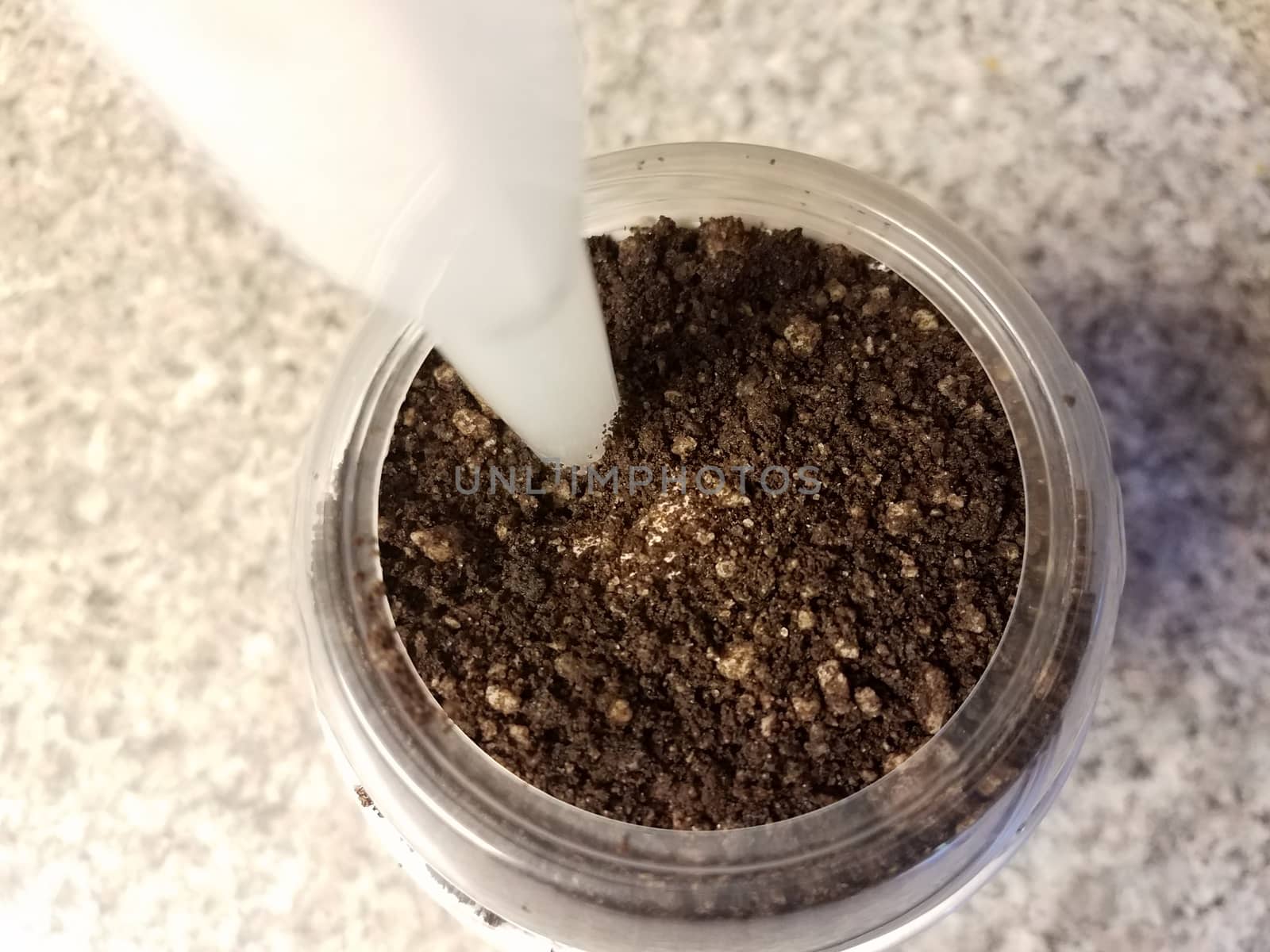 chocolate cookie ice cream in container or cup with straw