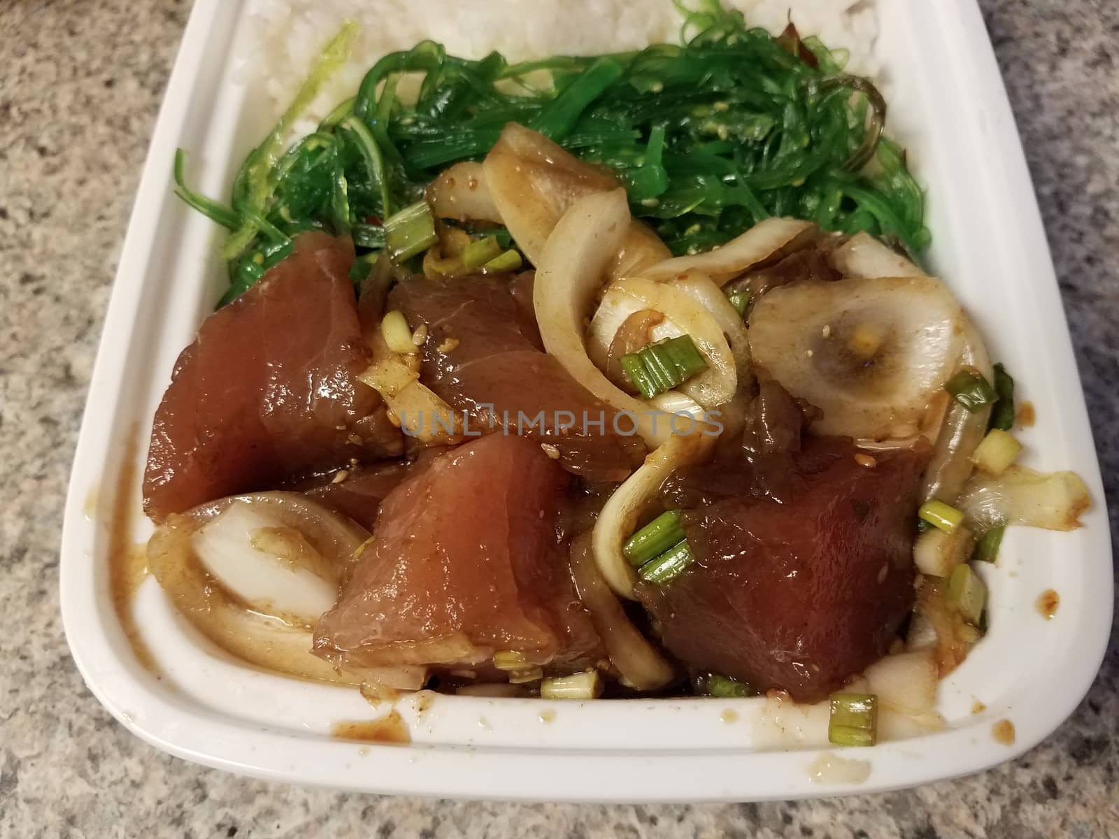 raw tuna fish and onion and seaweed in container