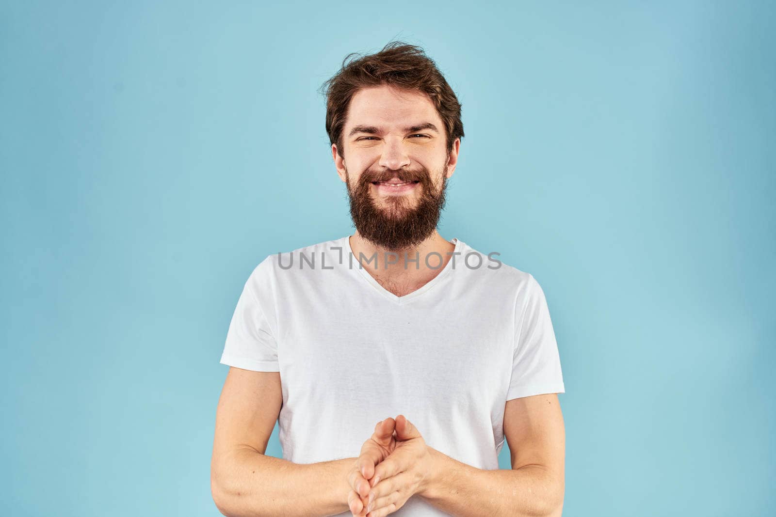 Emotional man with a beard in a white t-shirt blue background fun lifestyle by SHOTPRIME