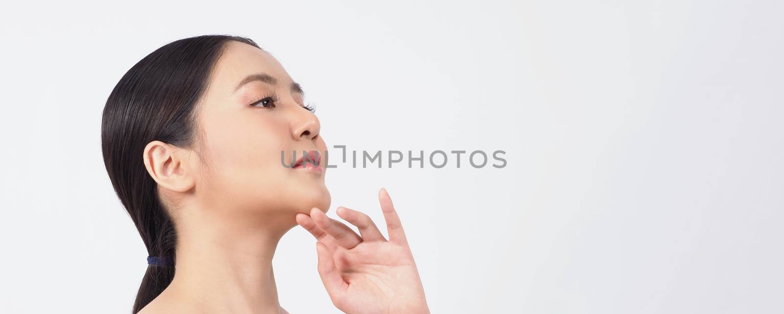 Young asian woman beauty face make up for skincare cosmetic and showing natural wellness soft and firm and ageless facial skin. she younger-looking or youthful. studio shot white background.