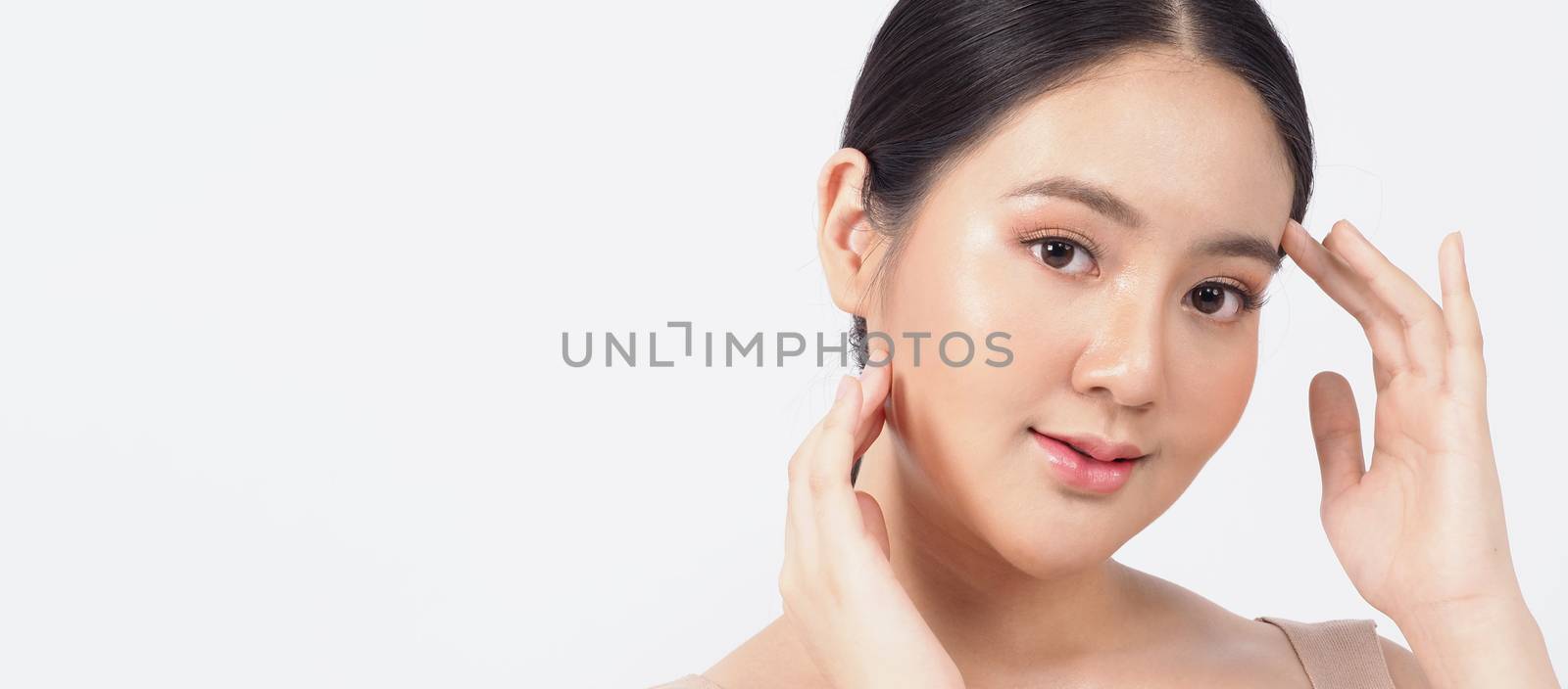 Young asian woman beauty face make up for skincare cosmetic and showing natural wellness soft and firm and ageless facial skin. she younger-looking or youthful. studio shot white background.
