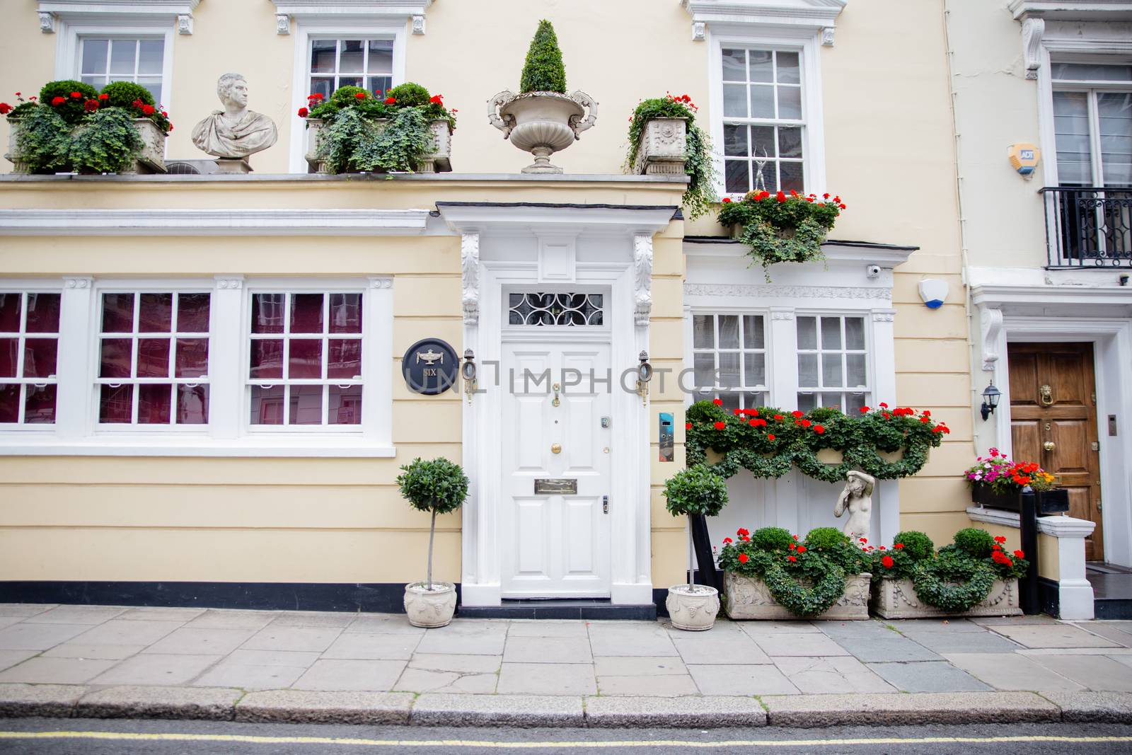 Picture of a flower decorated yellow house from a British neighbourhood