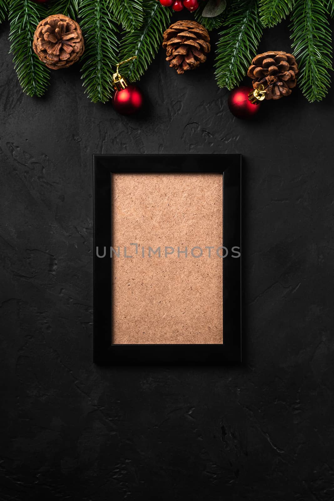 Christmas composition with empty picture frame. Colorful ornament, pine cones and fir needles decorations. Mock up greetings card template