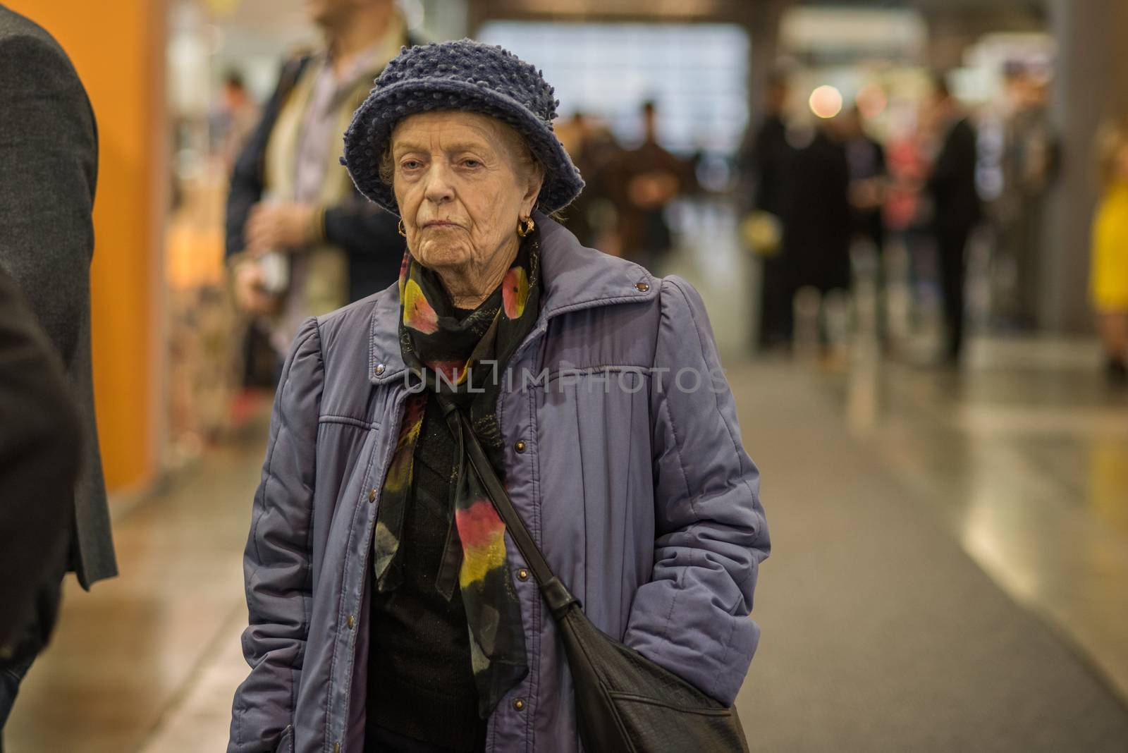 Old woman walking at a convention in Brno Exhibition Center (BVV trade fairs brno)