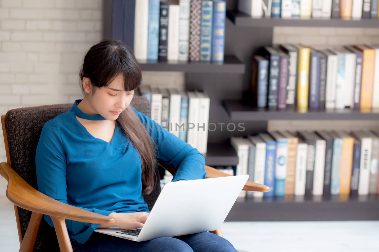 Business young asian woman freelance work on display laptop computer on chair, businesswoman check email, asia girl searching to internet communication and business concept.