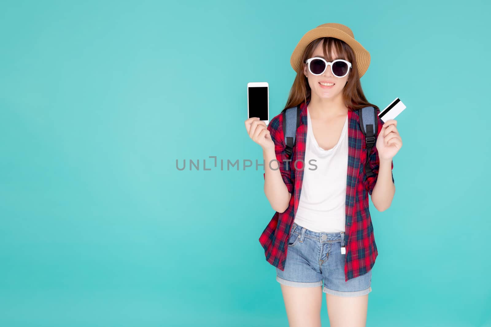 Beautiful portrait young asian woman wear travel summer fashion holding credit card and smart mobile phone in summer, asia girl payment for booking internet online with app in vacation.