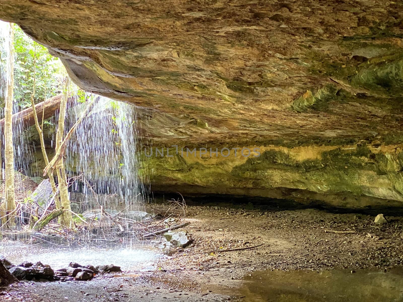 Tranquil cave waterfall after rain