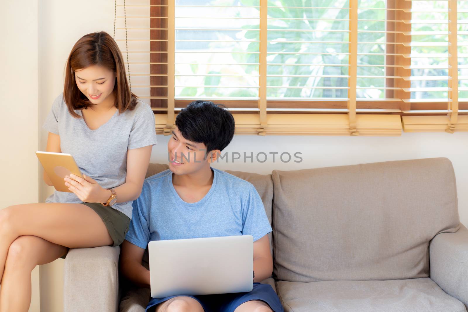 Beautiful young asian couple cheerful freelance working with man by nnudoo