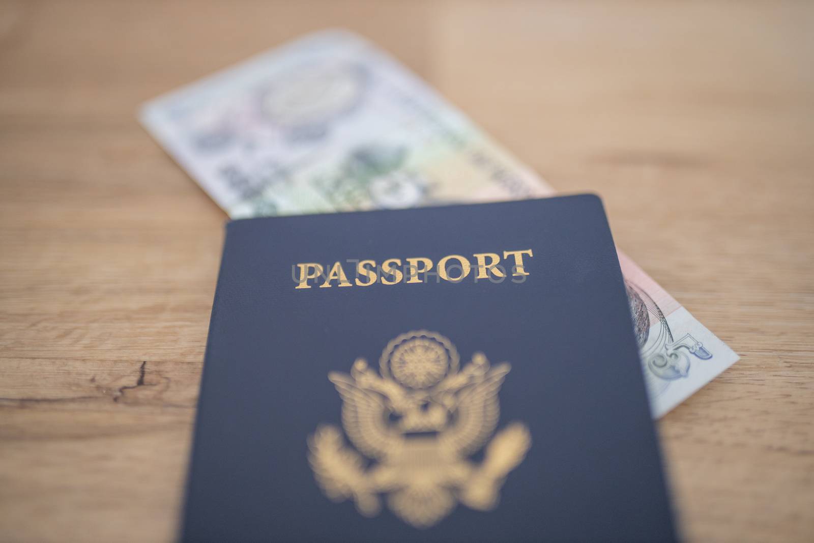 United States of America Passport with a blurry Five Honduran Lempiras Bill Partially Inside
