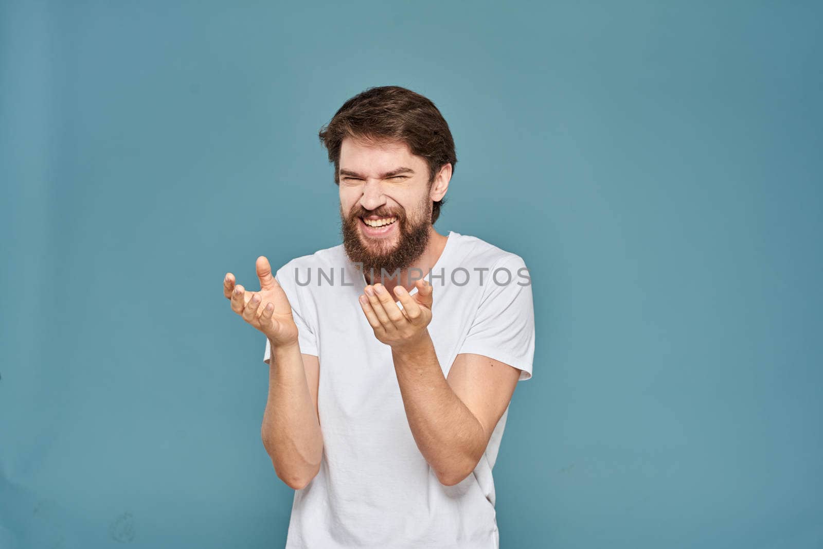 man in white t-shirt gesturing with his hands studio cropped by SHOTPRIME