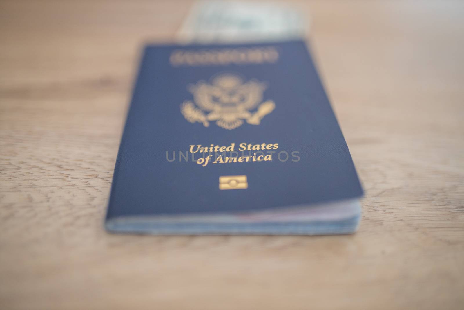 Picture of a blurry One-Dollar Bill Partially inside a United States of America Passport