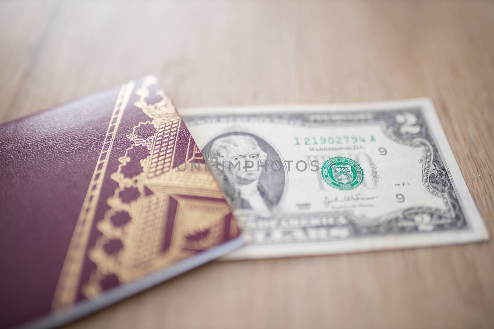 Two-Dollar Bill Partially Inside a Blurry Sweden Passport, Showing the face of Thomas Jefferson