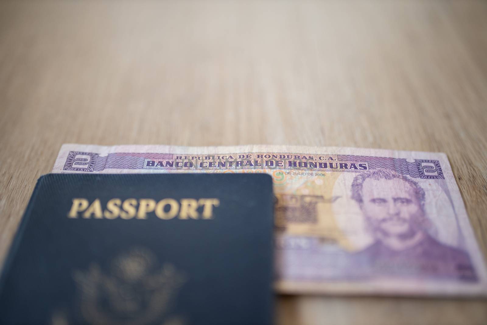 United States of America Passport with a Two Honduran Lempiras Bill partially under it, showing the face of Marco Aurelio Soto