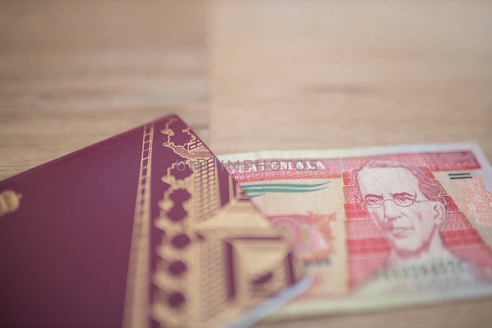 Picture of a Sweden Passport with a Ten Guatemalan Quetzales Bill partially Inside, showing the face of Miguel Garcia Granados