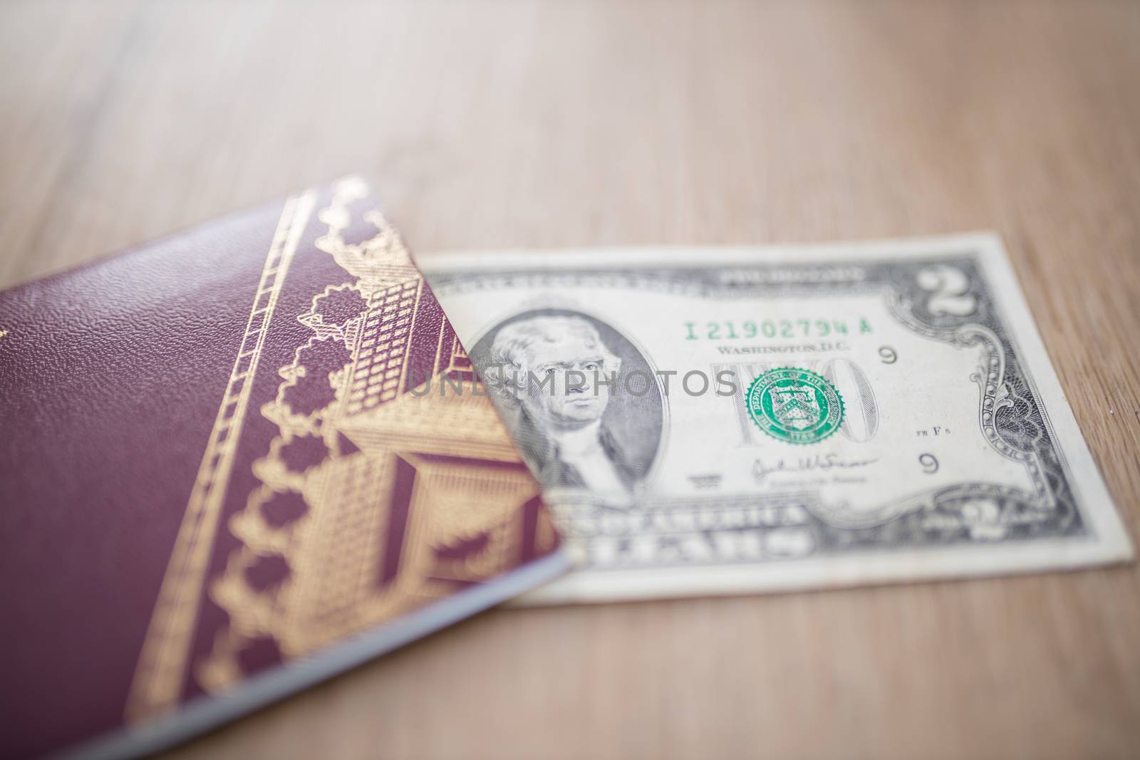 Two-Dollar Bill Partially Inside a Sweden Passport, Showing the face of Thomas Jefferson