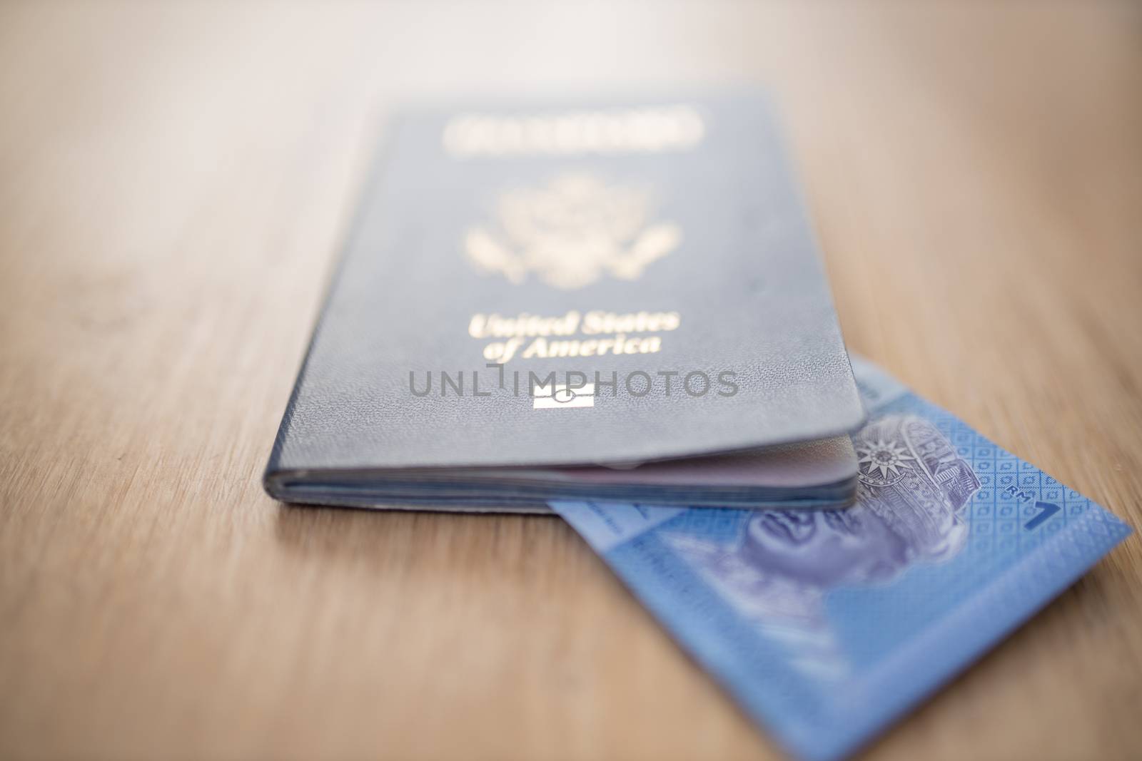 Picture of a One Malaysian Ringgit Note partially inside a United States of America Passport