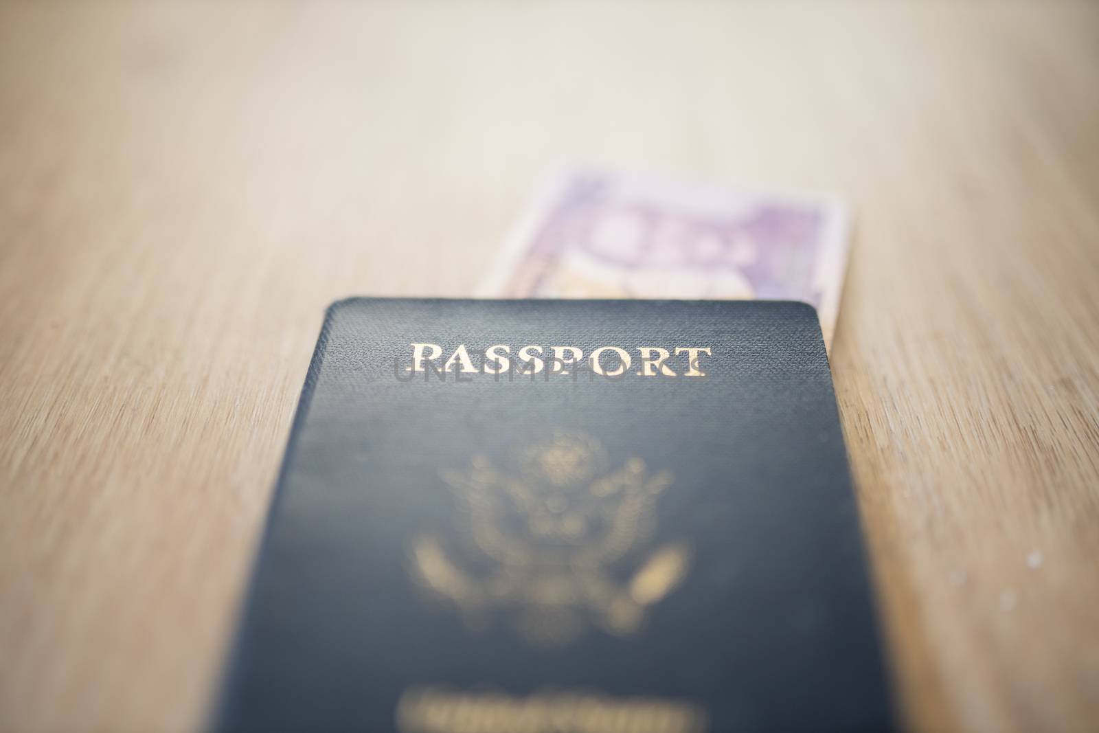 United States of America Passport with a Blurry Two Honduran Lempiras Bill partially under it