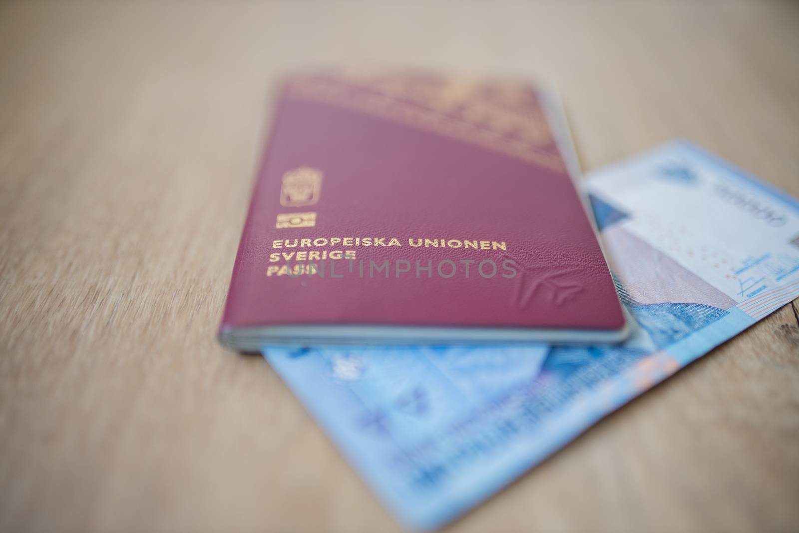 Picture of a Fifty Thousand Indonesian Rupees Bill partially inside a Sweden Passport