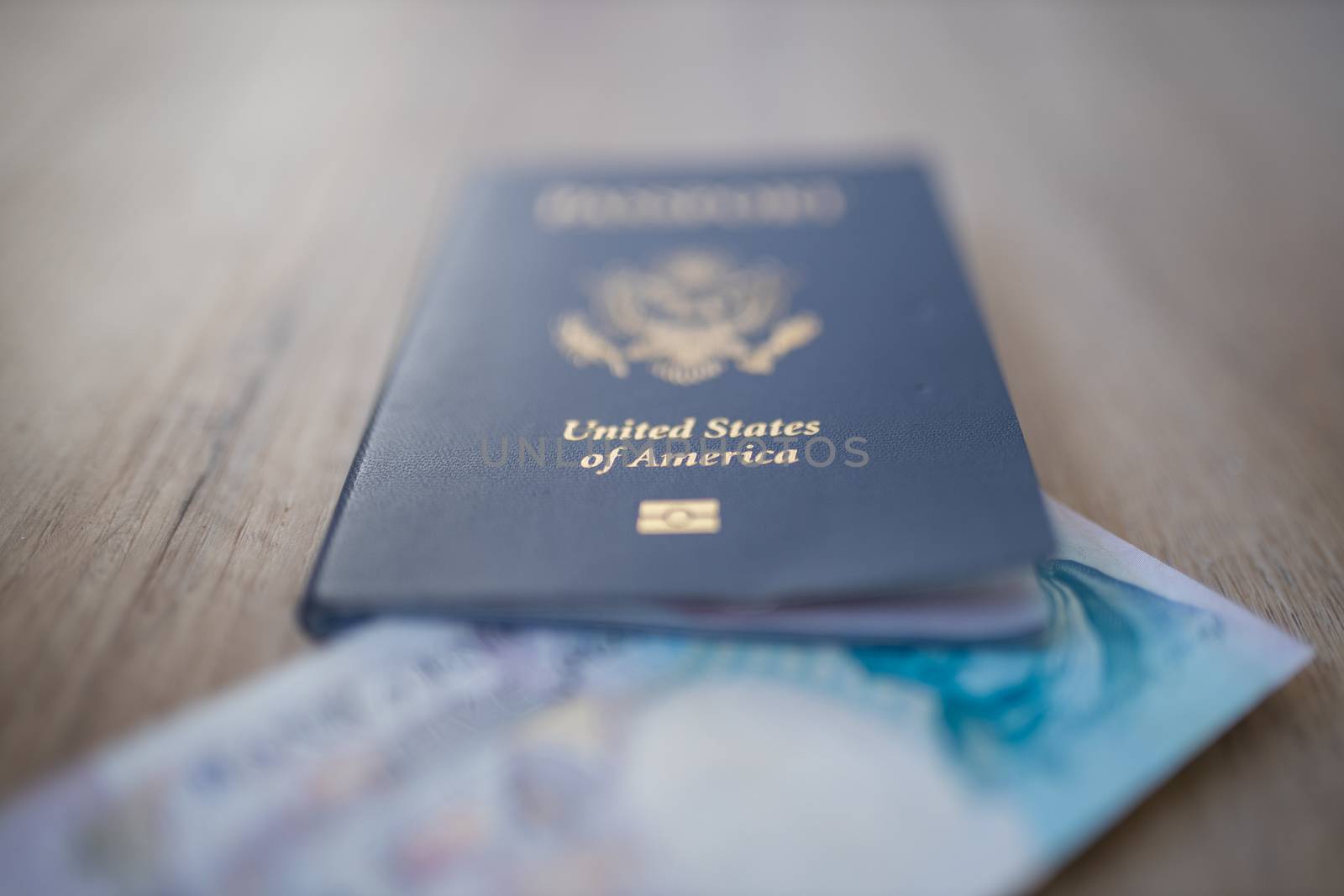 United States of America Passport with a Blurry Five Pound note inside covering the face of George Stephenson