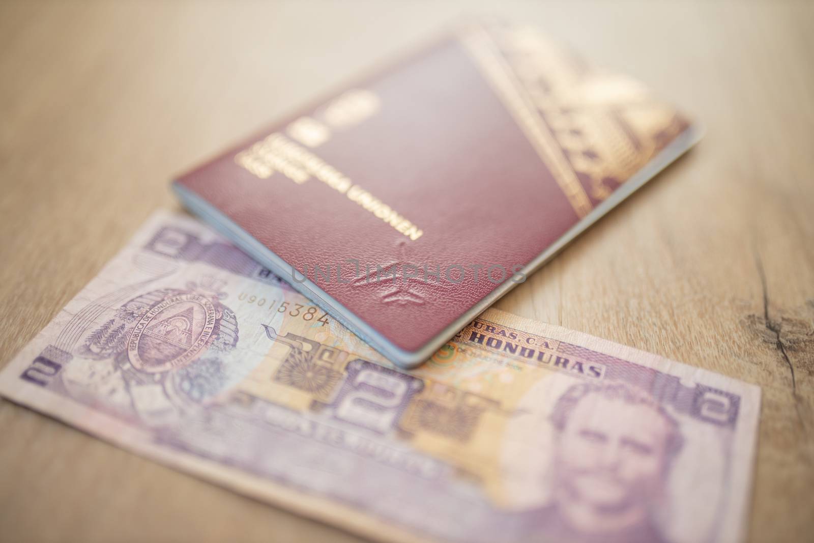 Picture of a Swedish Passport with a Two Honduran Lempiras Bill partially inside it, showing the face of Marco Aurelio Soto