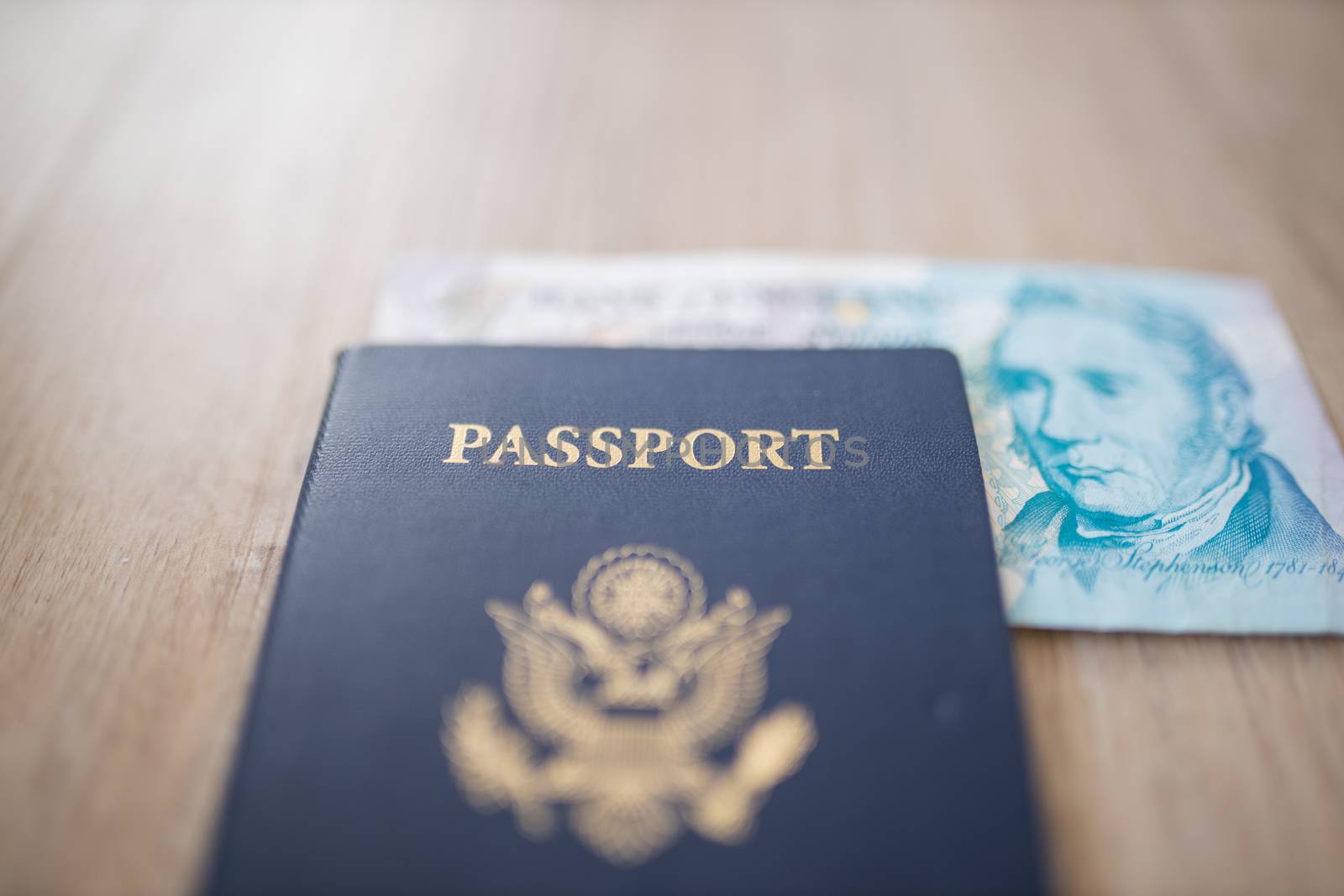 United States of America Passport with Half a Five Pound Note inside, showing the face of George Stephenson