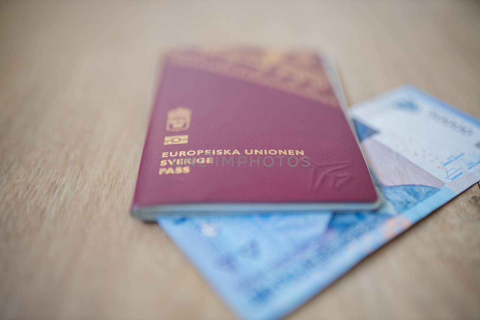 Picture of a Fifty Thousand Indonesian Rupees Bill partially inside a Sweden Passport