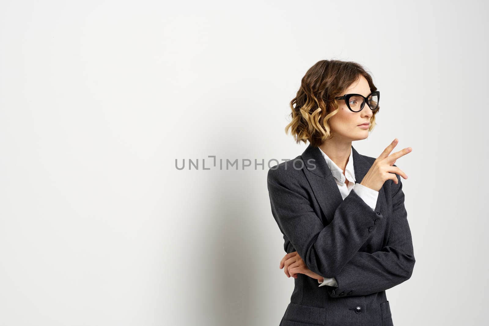 confident business woman in suit gesturing with hands work light background. High quality photo