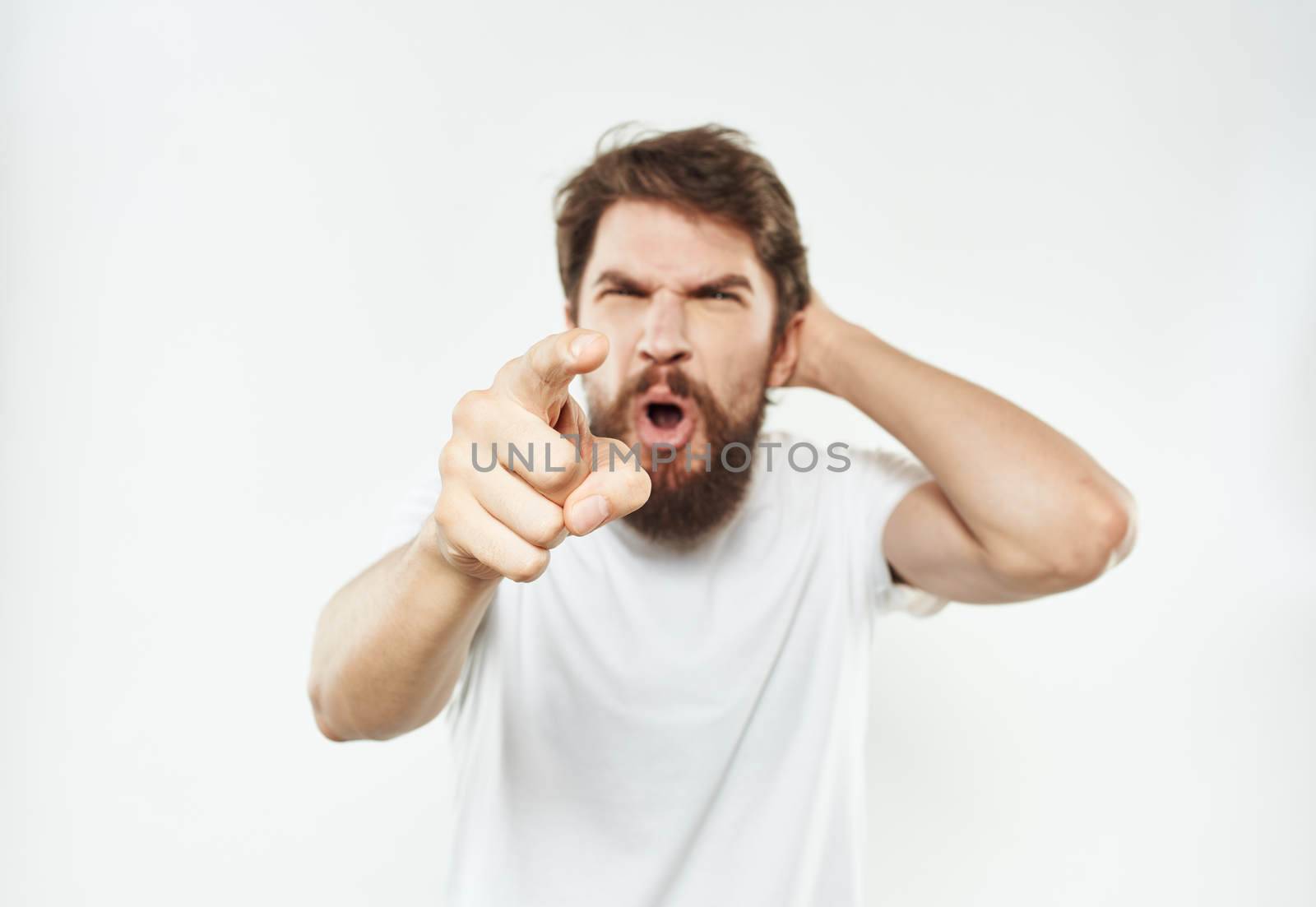An emotional man on a light background gestures with his hands Copy Space irritability by SHOTPRIME