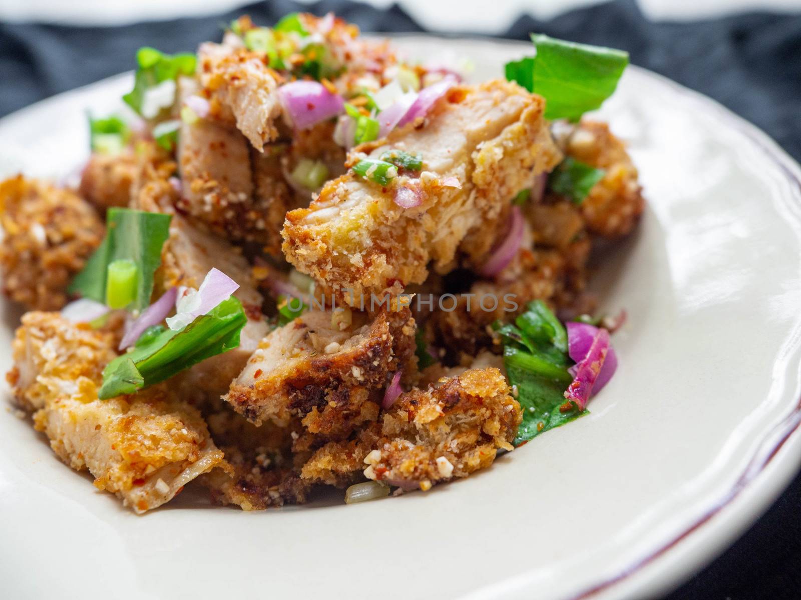 Thai food Spicy Chicken Salad is a favorite of locals in Thailand. You can find it in the street food stalls. Using fried chicken as a staple