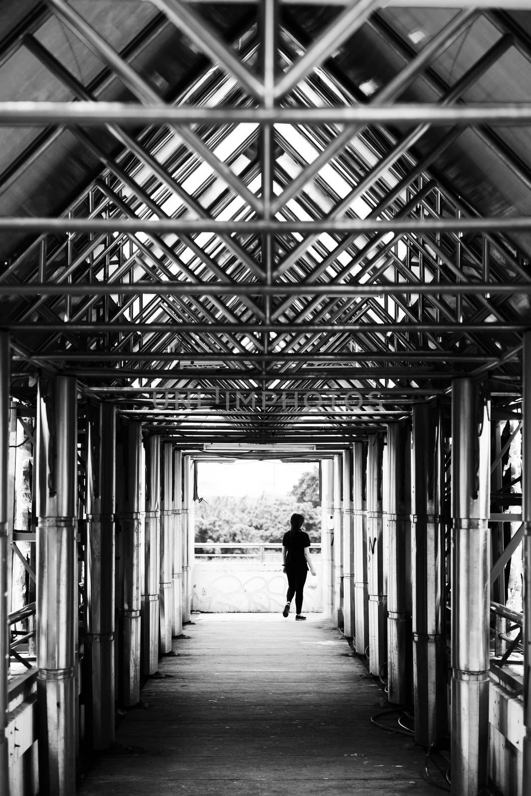 Women crossing overpass in black&white,beautiful architecture