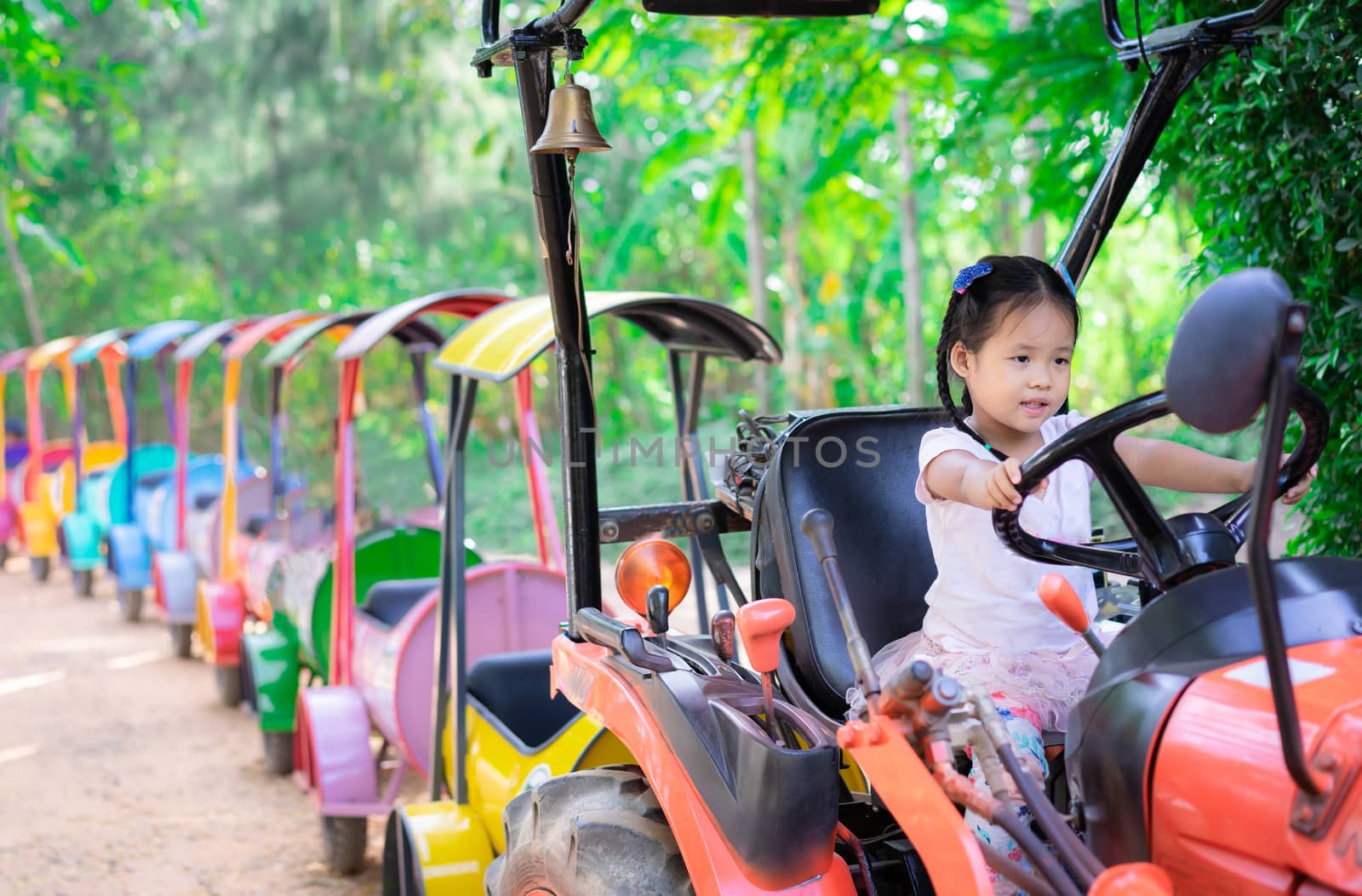 little girl playing to drive a train