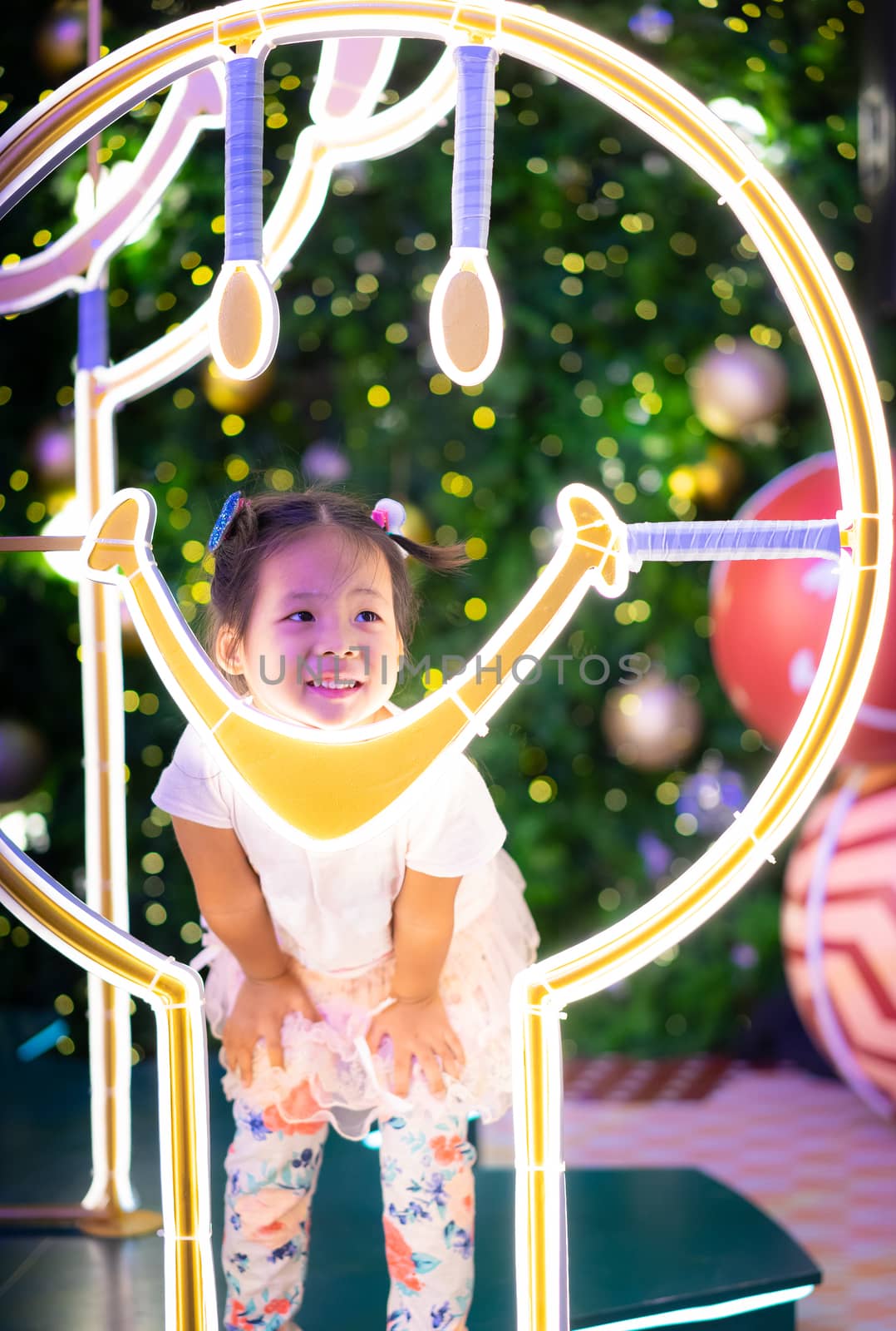 little asian girl smiling and bokeh background on Christmas day by domonite