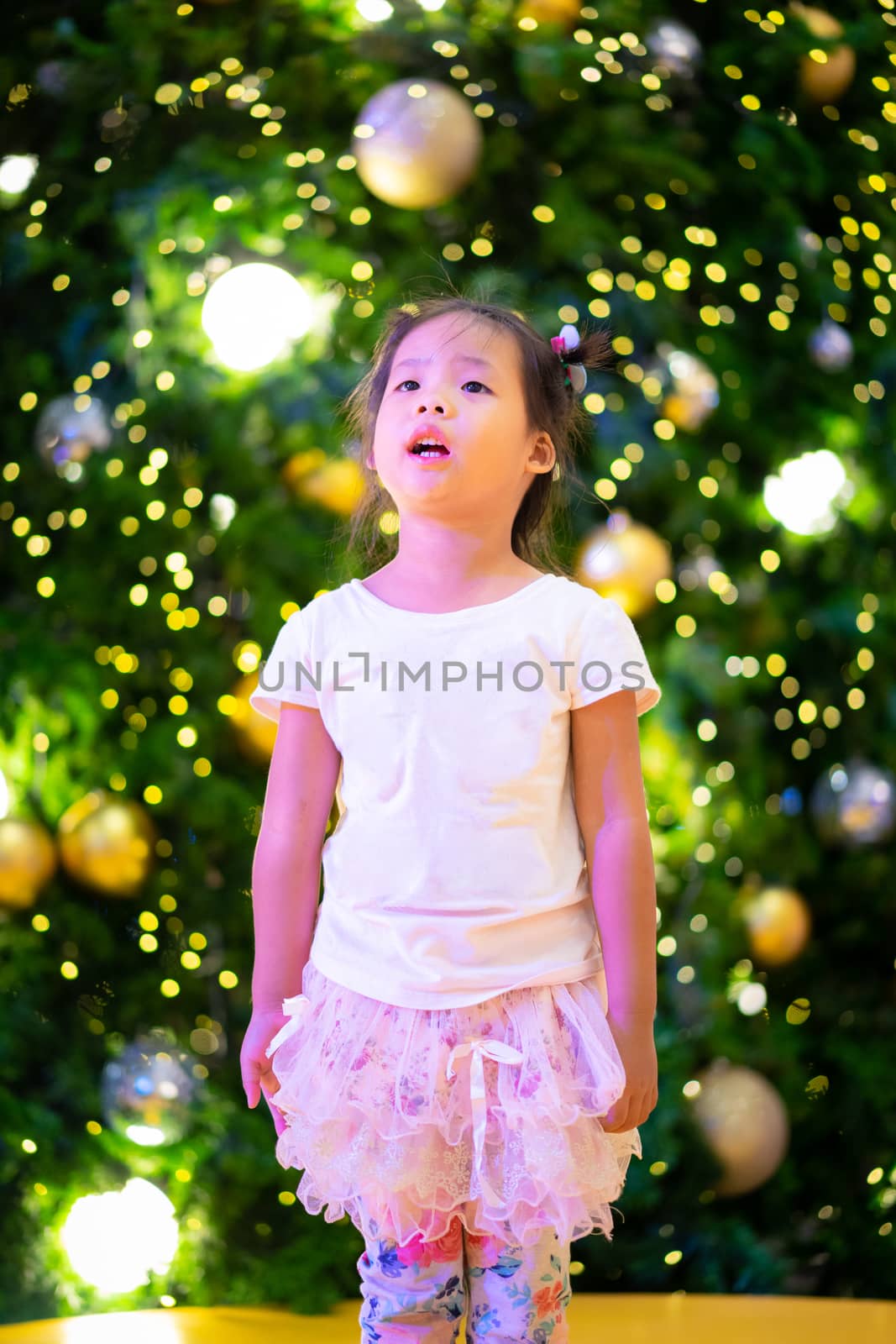 little asian girl and bokeh background on Christmas day by domonite