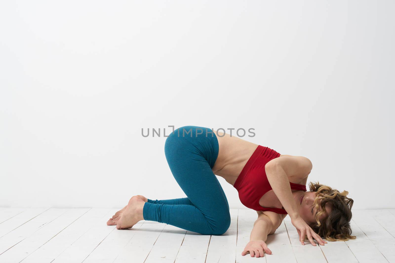 woman in leggings is engaged in gymnastics in a light room slim figure fitness sport. High quality photo